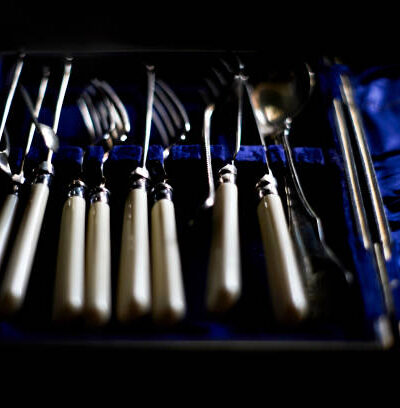 Defocused vintage cutlery in vintage blue box. blurred background